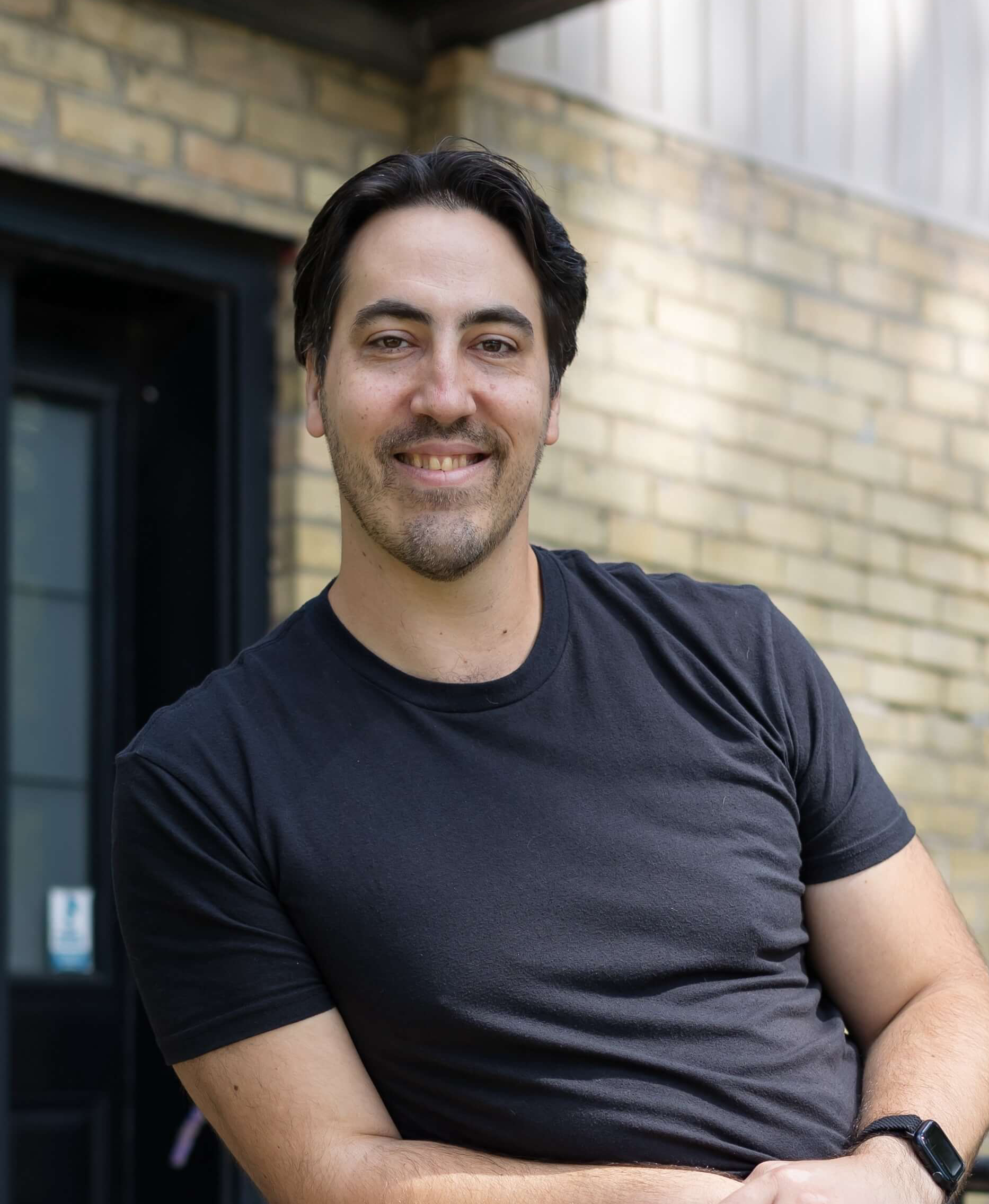 Man smiling with building background - embodied resilience