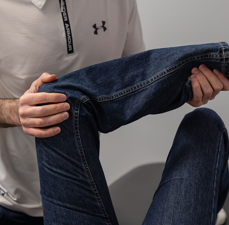 Physiotherapist doing physiotherapy work on a patient's leg.