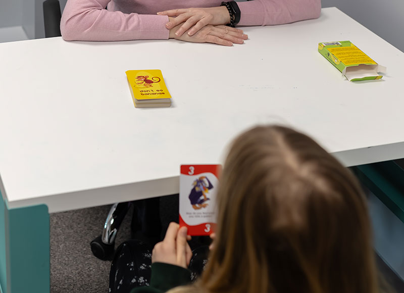 Psychotherapist and a patient utilizing a card game for therapy.