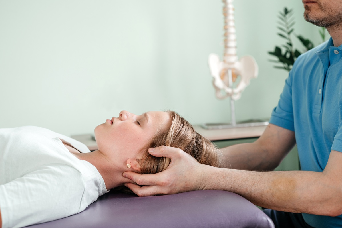 Girl receives chiropractic treatment from practitioner.
